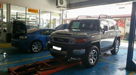An SUV on the alignment lift at Roadstar Katipunan