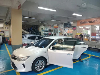 A sedan being serviced in the Roadstar Makati service bay